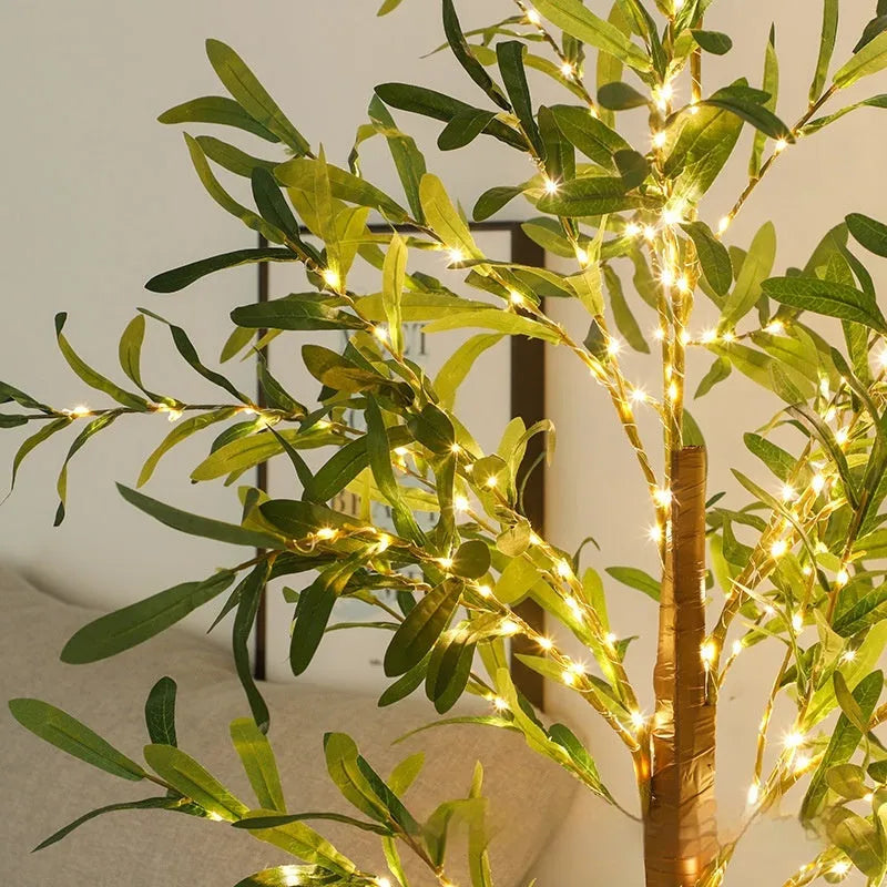Tall 1.8 metre simulation olive leaf tree lamp with warm white LEDs lit, showing abstract trunk design.