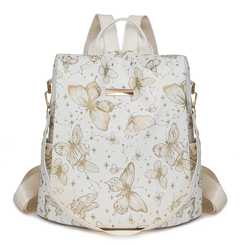 Butterfly print PU leather backpack in purple shown from the side, featuring sewing line details and shoulder straps.