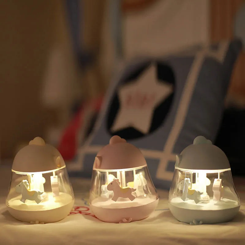 USB carousel music light with rotating trojan, music box, and warm yellow light on a desk.