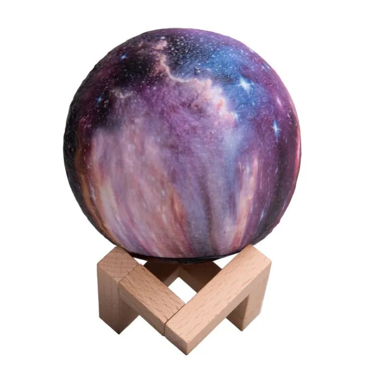 3D-printed white lunar sphere LED night light on a dark surface, showing detailed crater texture.