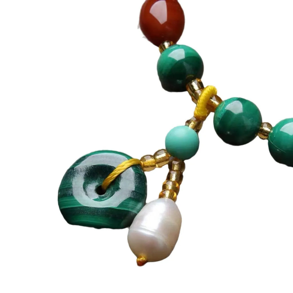 Natural green malachite and red agate barrel bead bracelet on wrist, bead size 7-8mm.