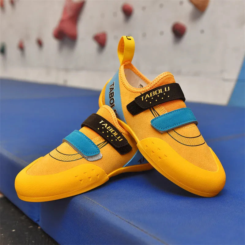 Beginner rock climbing shoes with Velcro fastening in black with red, orange yellow, or pink accents