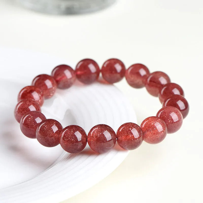 Natural strawberry quartz bracelet showing cherry red colour with starlight effects on geometric beads