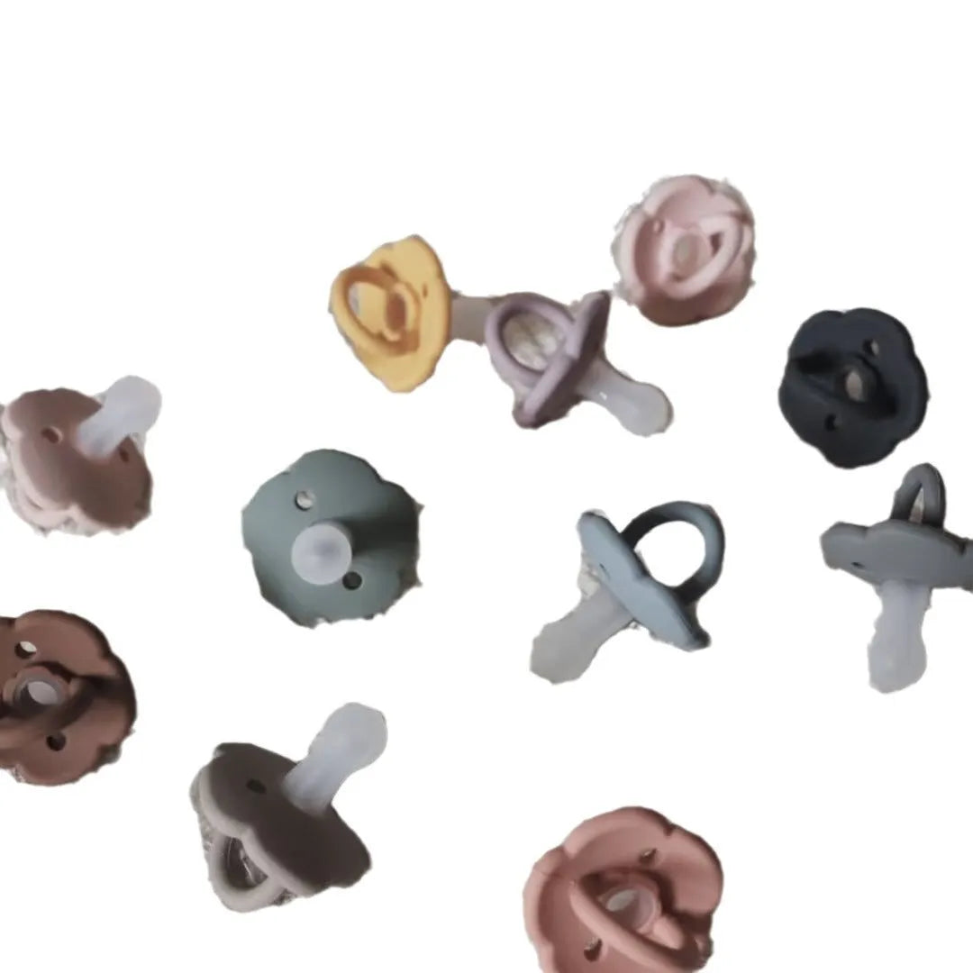 Baby pacifier with silicone lace nipple in 6.5x5x5cm size available in 11 colours for 0-6 months