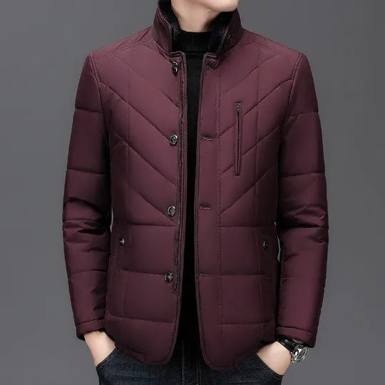 Men's dark blue winter short padded coat with side pockets on a solid background.