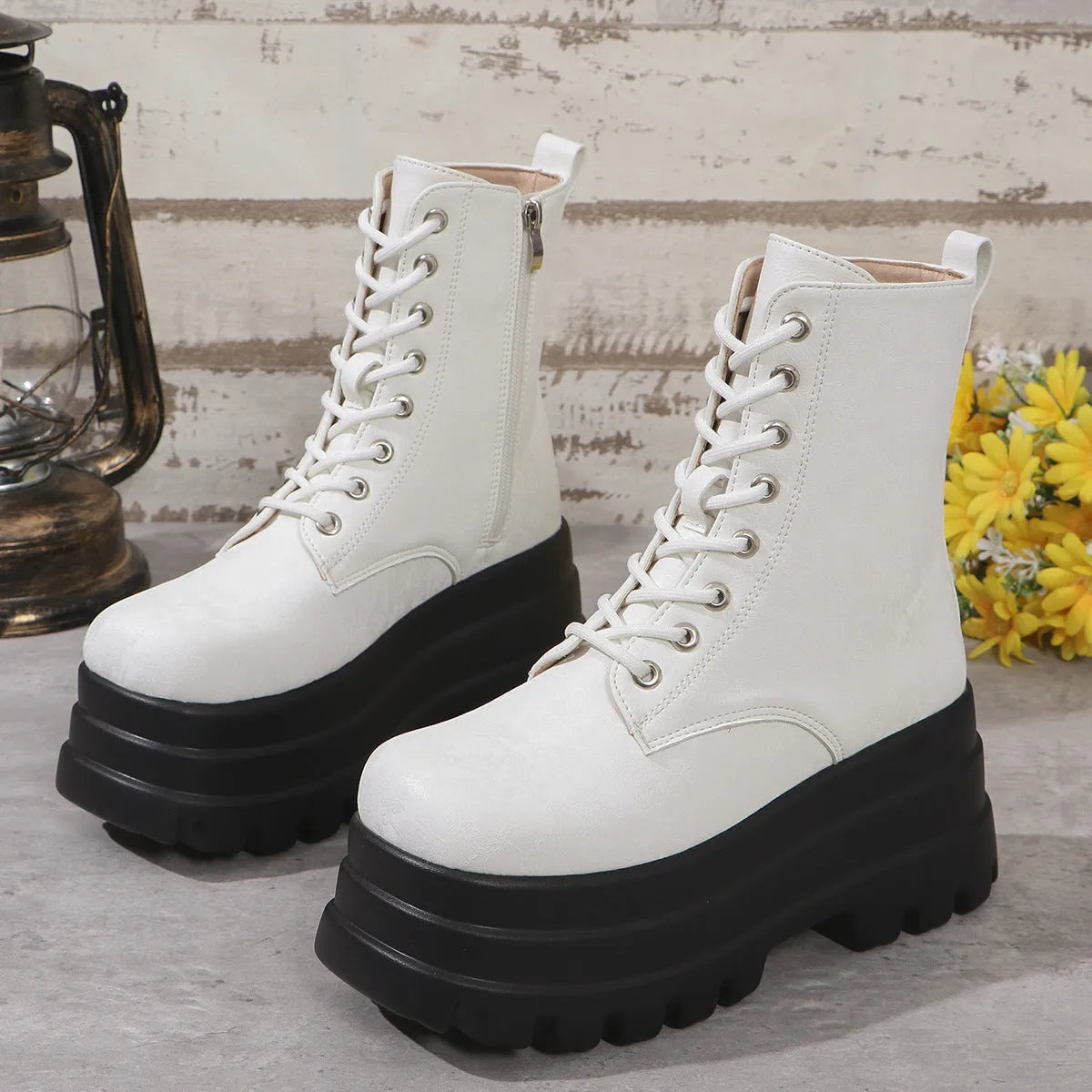 Women's black platform Martin boots with side zip and chunky rubber sole.