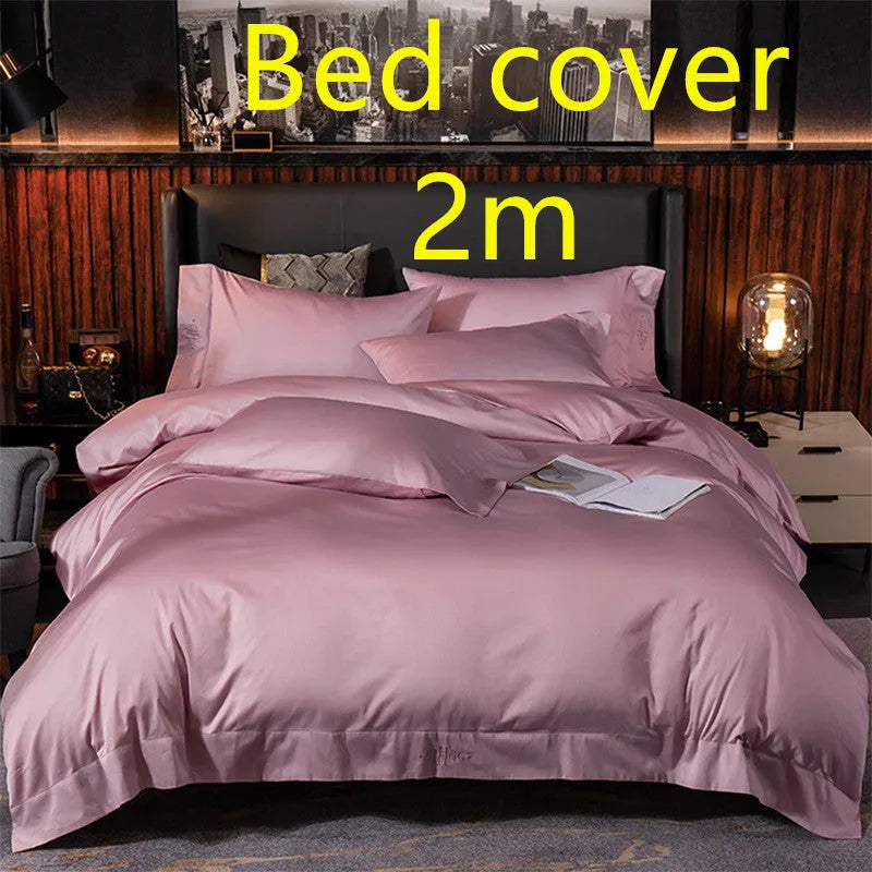 Four-piece cotton satin quilted bedding set with duvet cover, sheet, and pillowcases in a bedroom setting