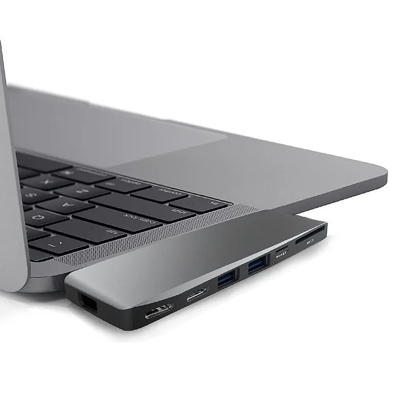 USB-C expansion adapter with eight ports for MacBook Pro showing dual connectors and multiple interface options