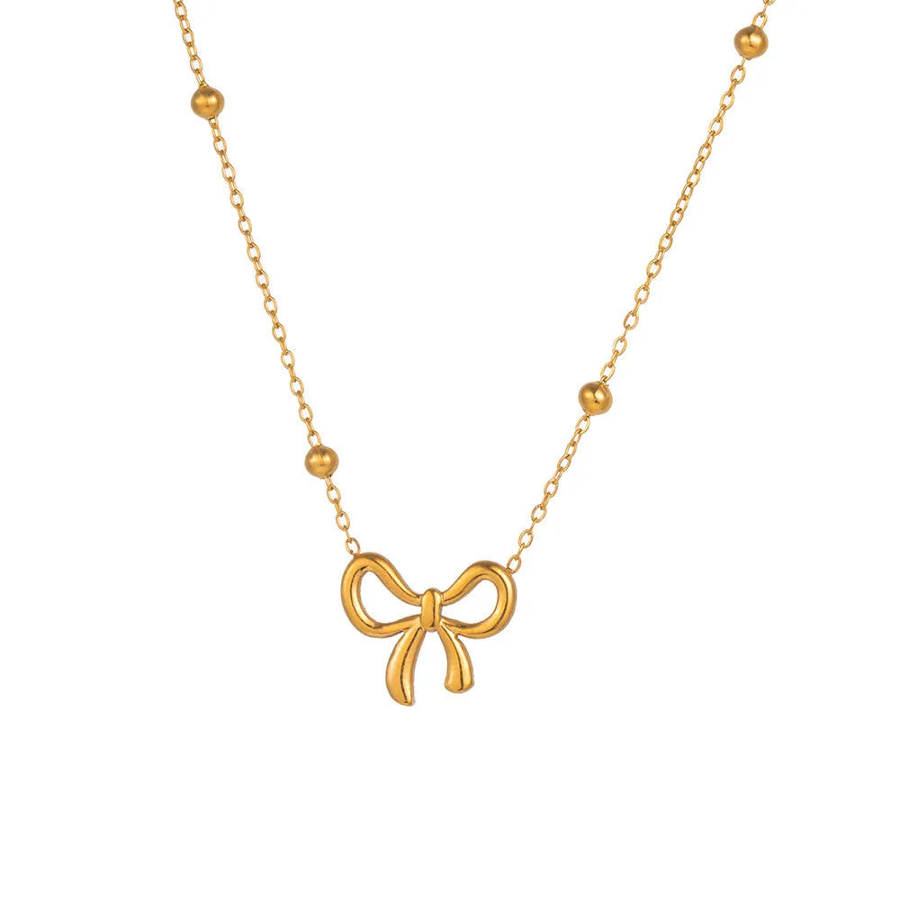 Gold-coloured bow pendant necklace on a cross-link chain, adjustable from 41 to 50 cm.