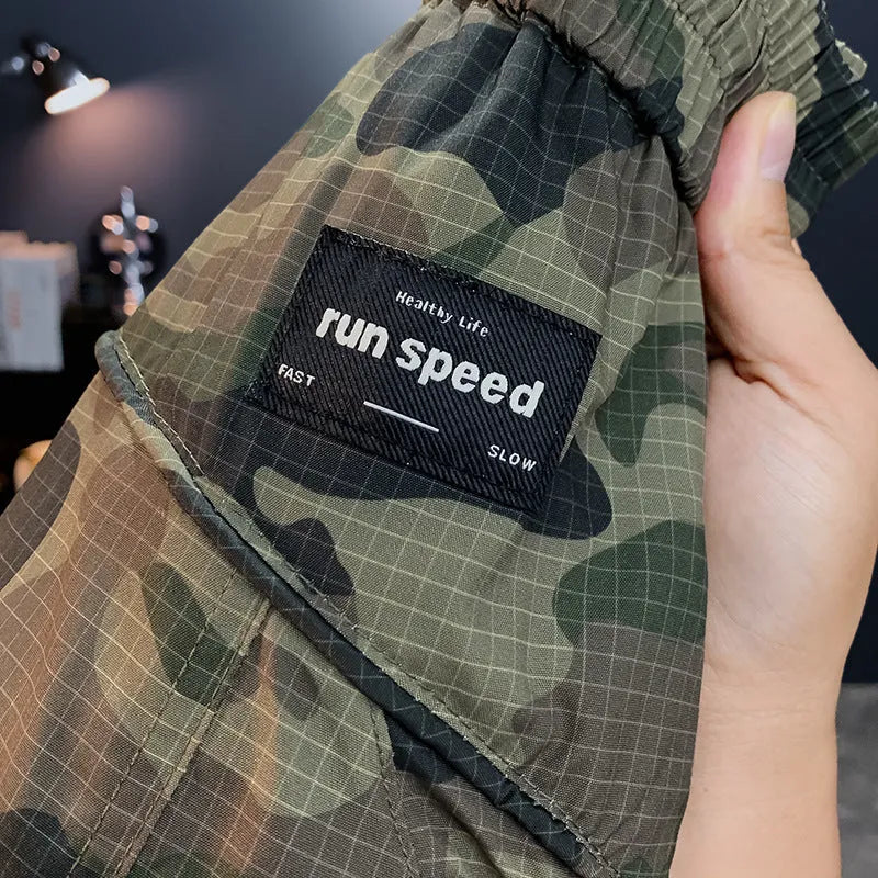 Men's camouflage pattern loose-fit cotton blend cargo shorts on a hanger