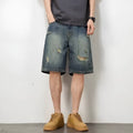 Blue distressed denim men's shorts with a loose retro fit and hole detailing
