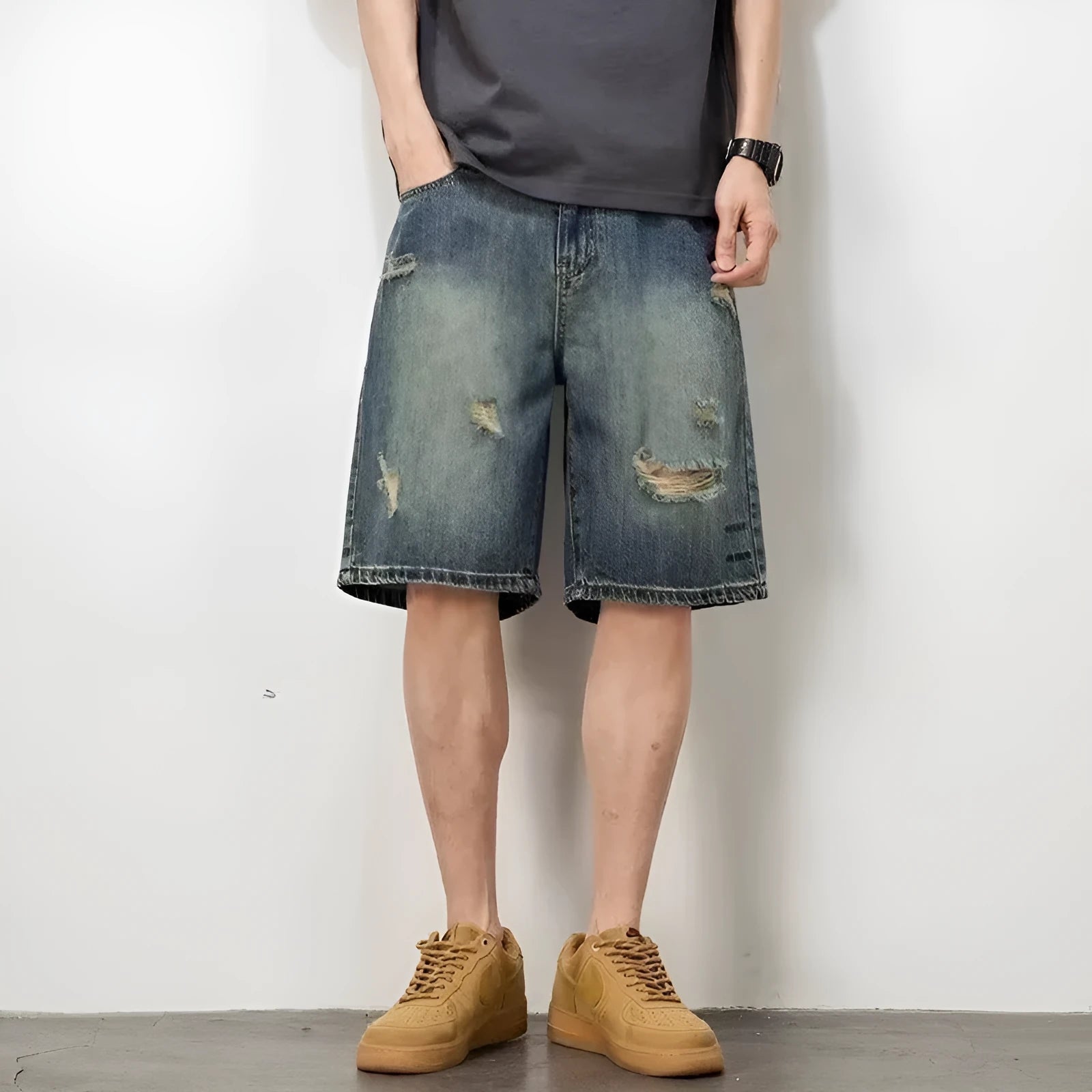 Blue distressed denim men's shorts with a loose retro fit and hole detailing