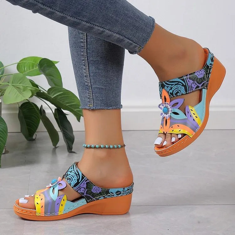 Ethnic slope and totem design slippers in cowhide with a round toe and rubber sole, shown in multiple colours.