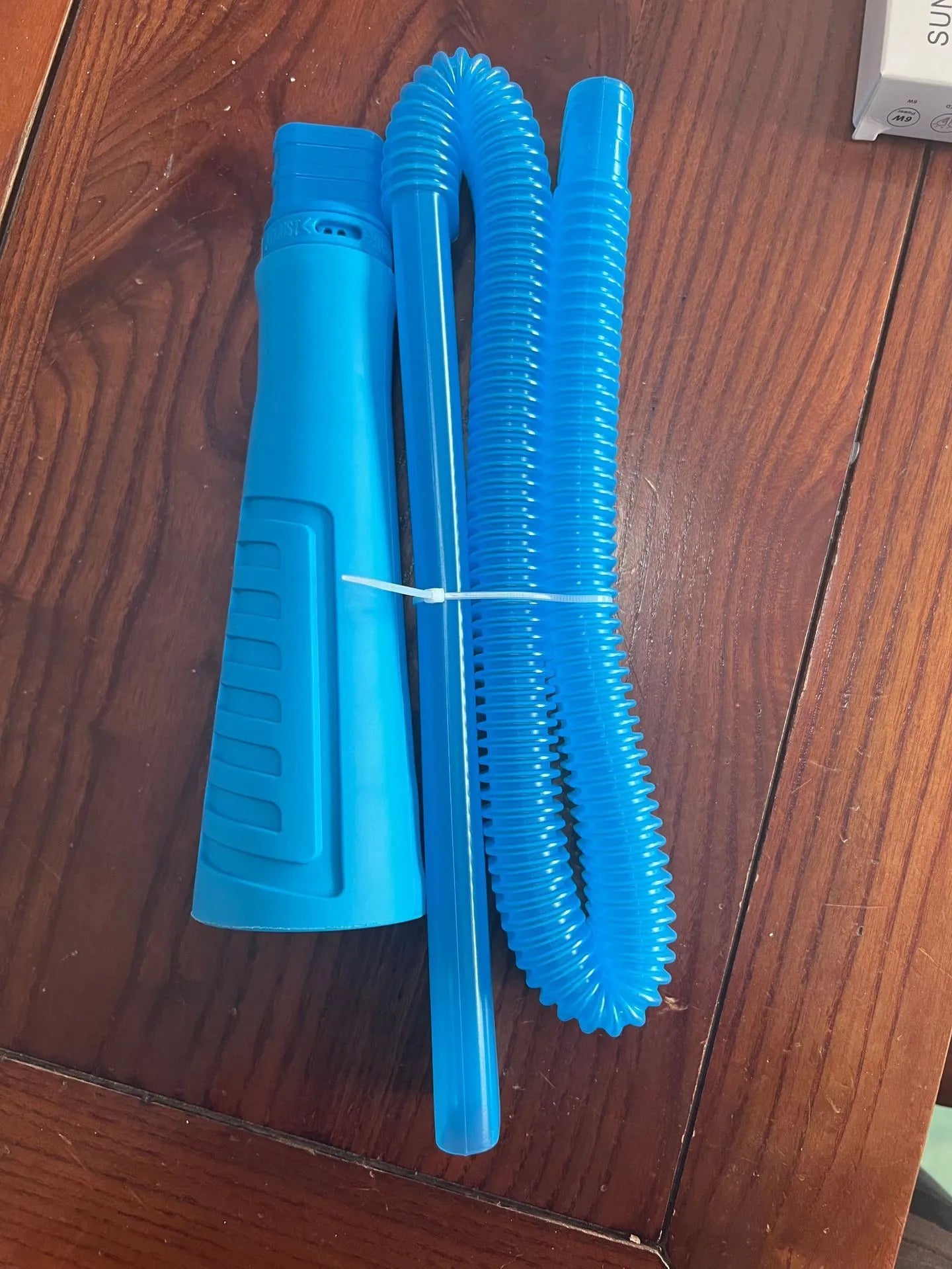 Blue plastic suction pipe cleaner with round head connector for vacuum hose attachment