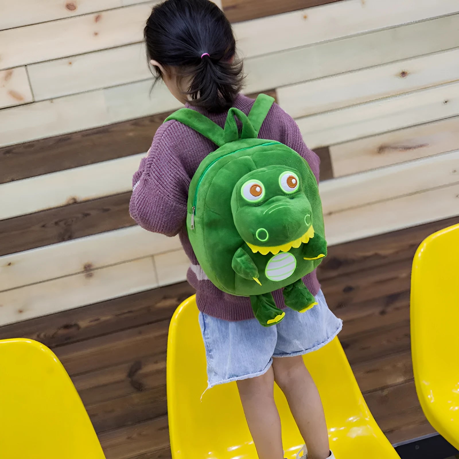 Blue dinosaur plush backpack for children with embroidered design and soft handle