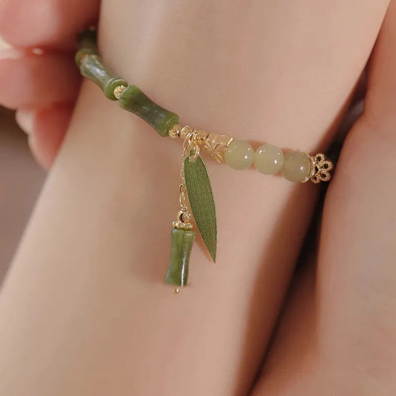 Chinese style glass bracelet with bamboo joint elements in red Lvzhu Duobao design