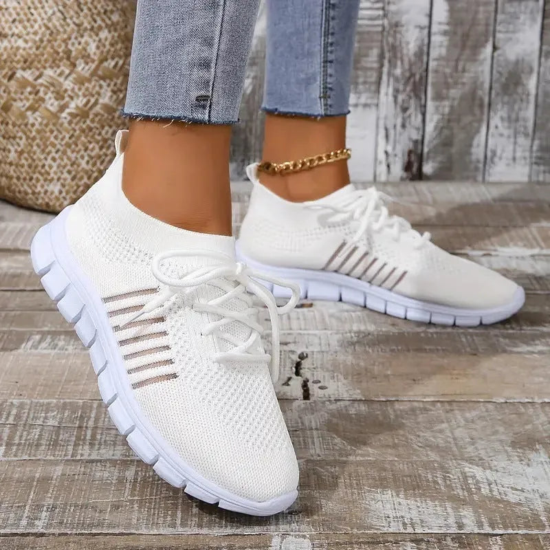 Ladies casual flat shoes in beige with breathable mesh upper, round toe, and front lace closure.
