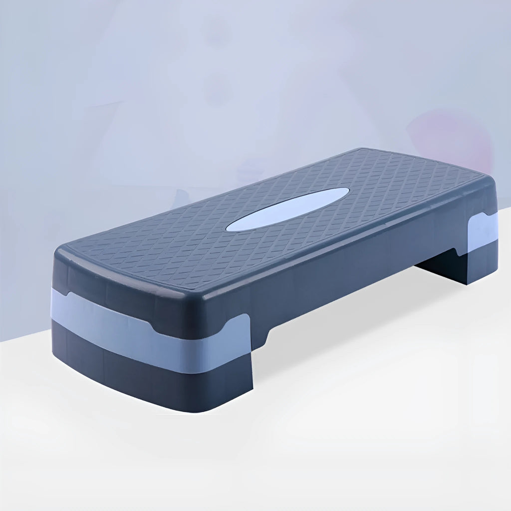 Grey Fit Step aerobic platform on a wooden floor, showing its non-slip textured surface.