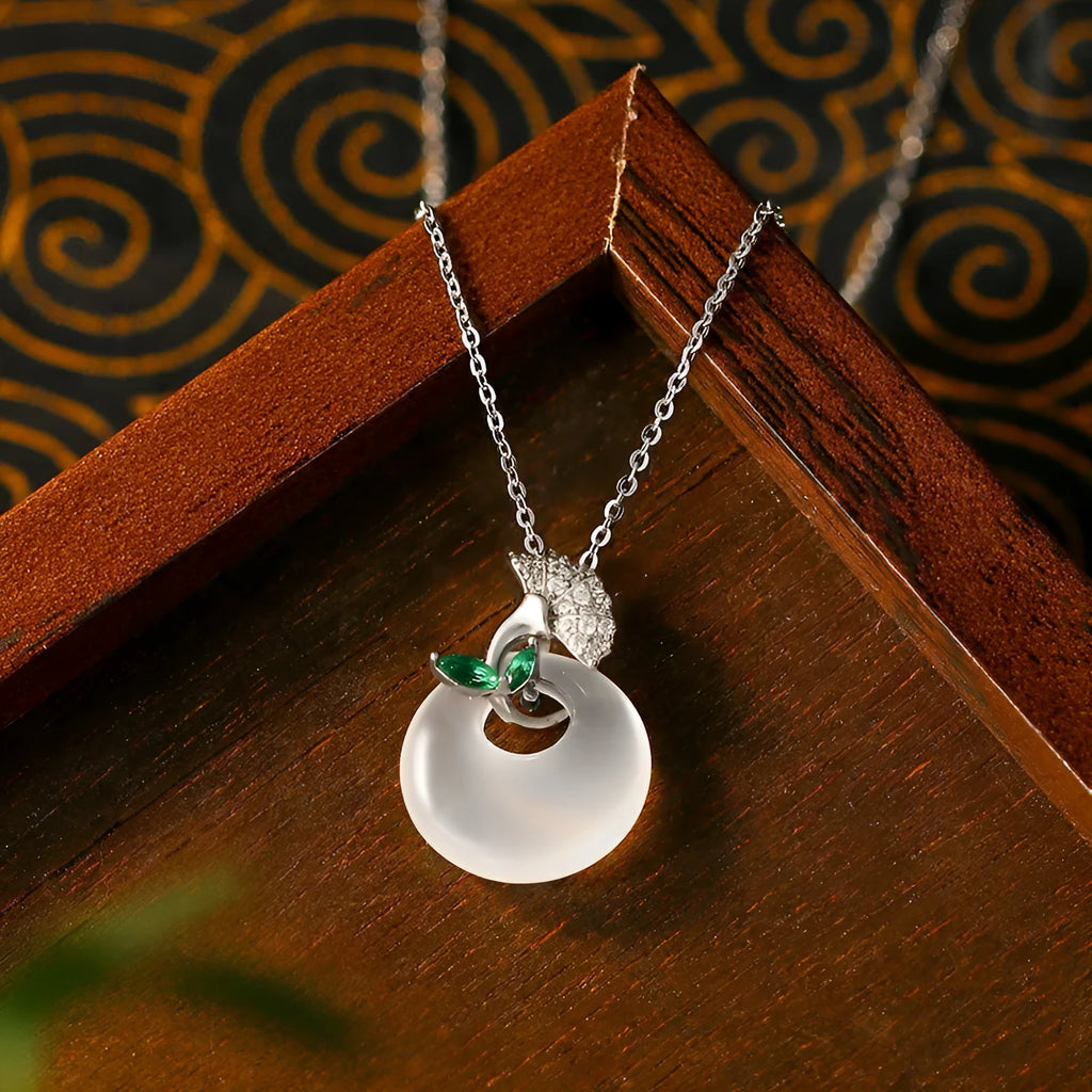 White ginkgo leaf pendant necklace with mixed gem inlay on silver electroplated O-ring chain