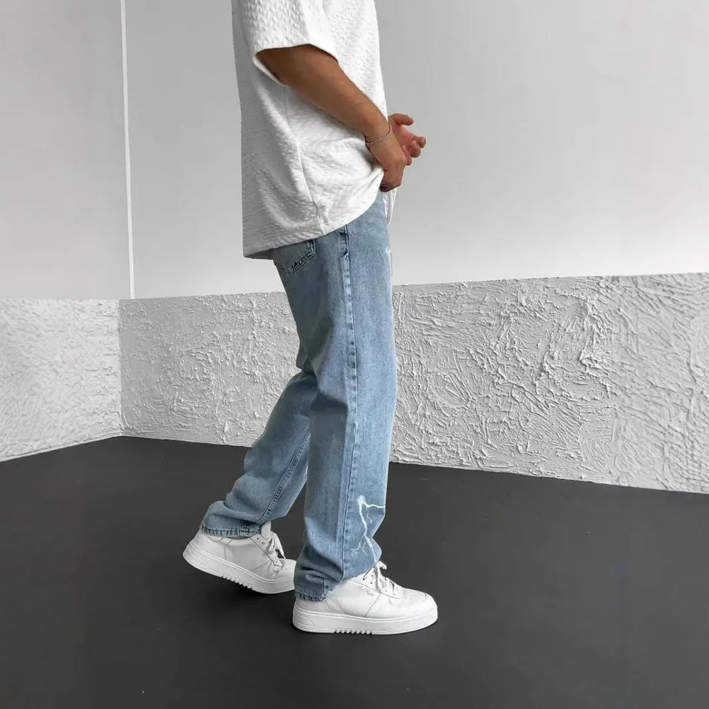Men's blue straight-leg denim jeans with mid waist and zipper fly on solid background