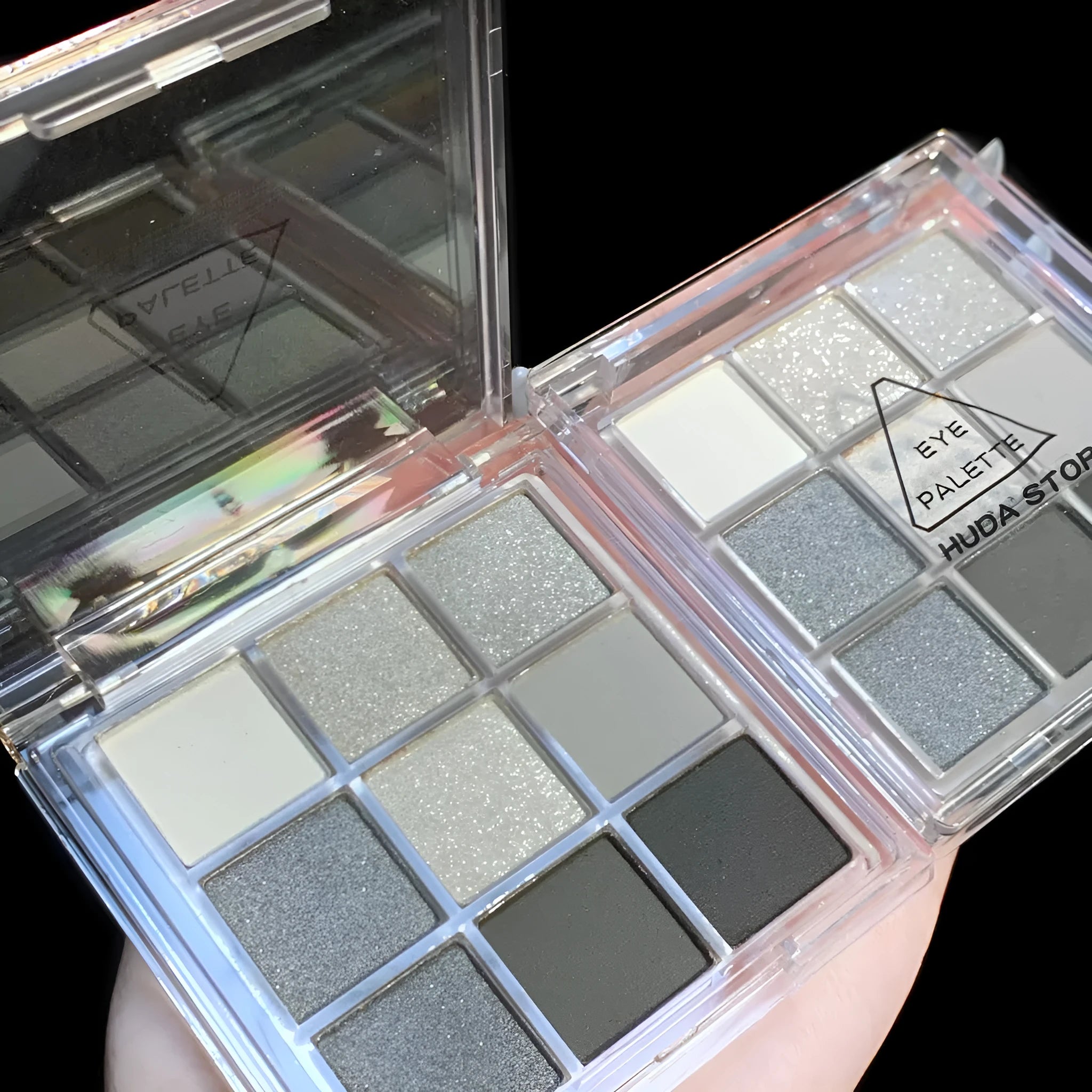 Nine-colour smoked eye shadow plate showing white, silver, black, and iron grey shades in INS style case