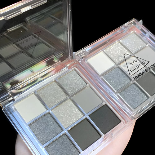 Nine-colour smoked eye shadow plate showing white, silver, black, and iron grey shades in INS style case