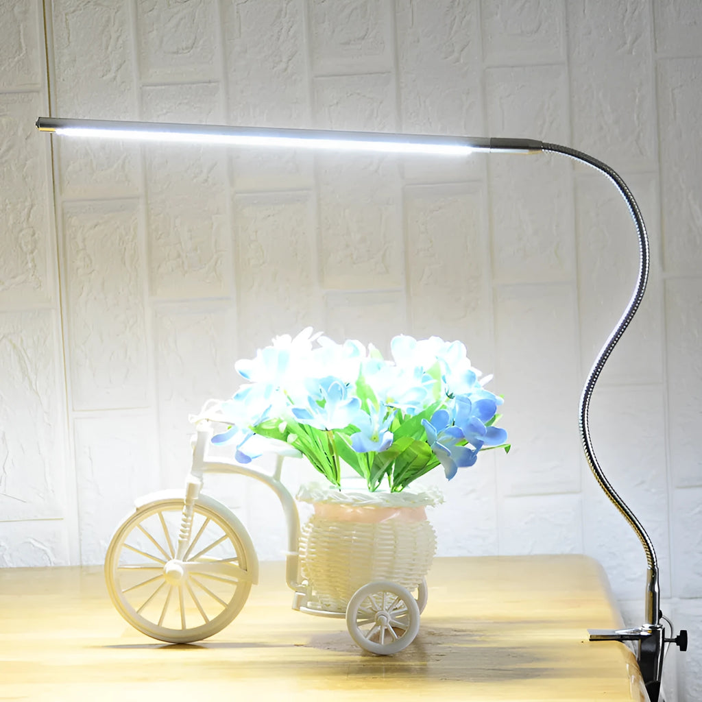 Silver aluminium USB-powered clip-on LED table lamp with a long arm extended, for nail art and detailed tasks.