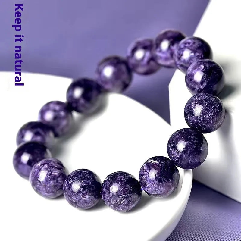 Natural transparent charoite crystal bracelet with platinum finish, showing different bead size options on a wrist.