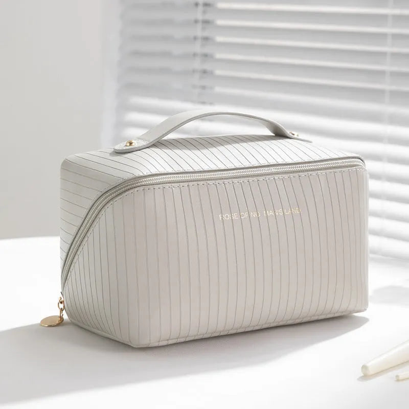 Vertical pattern cubic PU makeup bag in beige, shown with dimensions 22.5cm by 12.5cm.