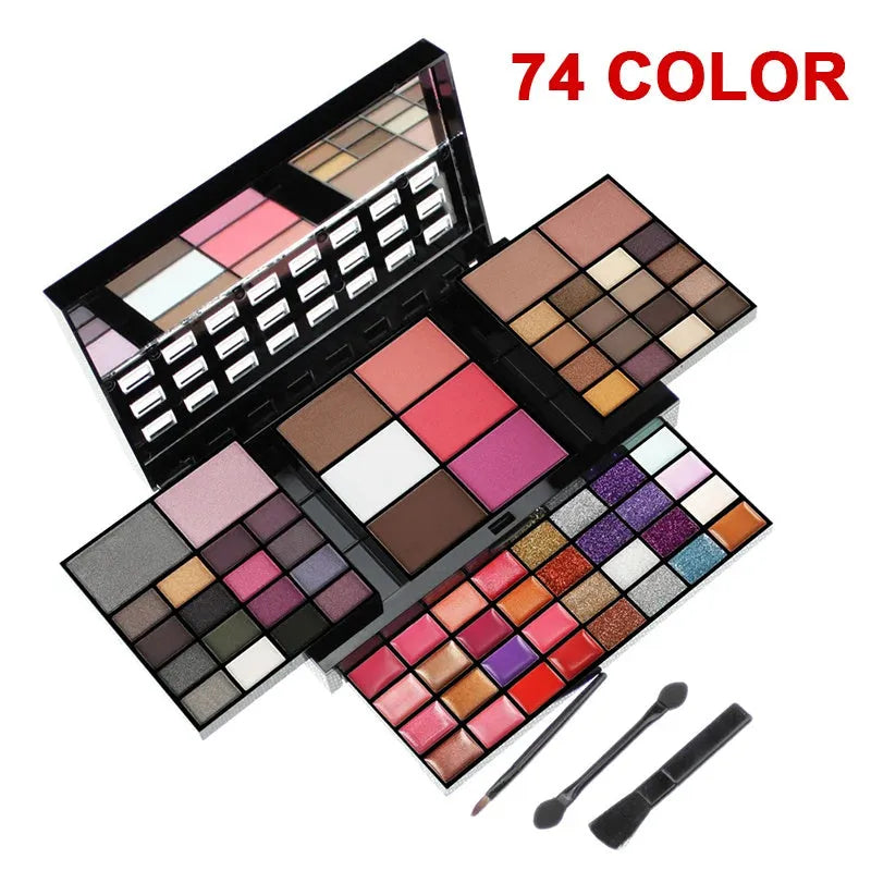 74 colour makeup palette open showing layered powder plates with eyeshadows, lip glosses, blush and contour, with mirror and brushes.