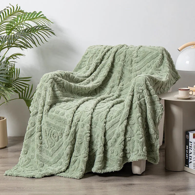 Cotton velvet jacquard sofa blanket showing plant flower pattern on solid colour background