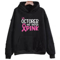 Woman wearing a pink retro pattern sweatshirt hoodie with side pocket.