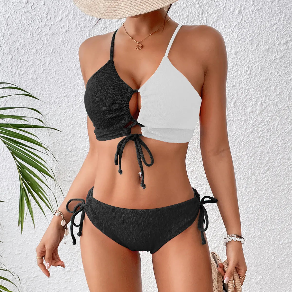 Women's black and white contrast colour cross sling hollow bikini set in polyester, front view
