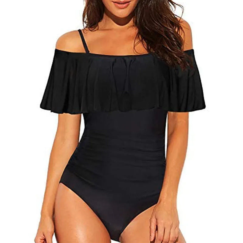 Black one-piece swimsuit with cut-out design and ruffled straps laid flat.