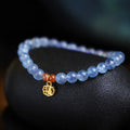 Women's ice translucent bracelet with 8mm crystal beads and a blessing card charm on a white background.