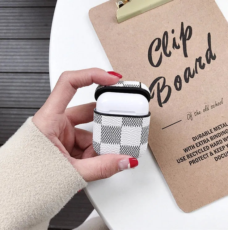 Hard plastic iPhone XS Max case with a hook for a Bluetooth headset, shown in a grid pattern design.