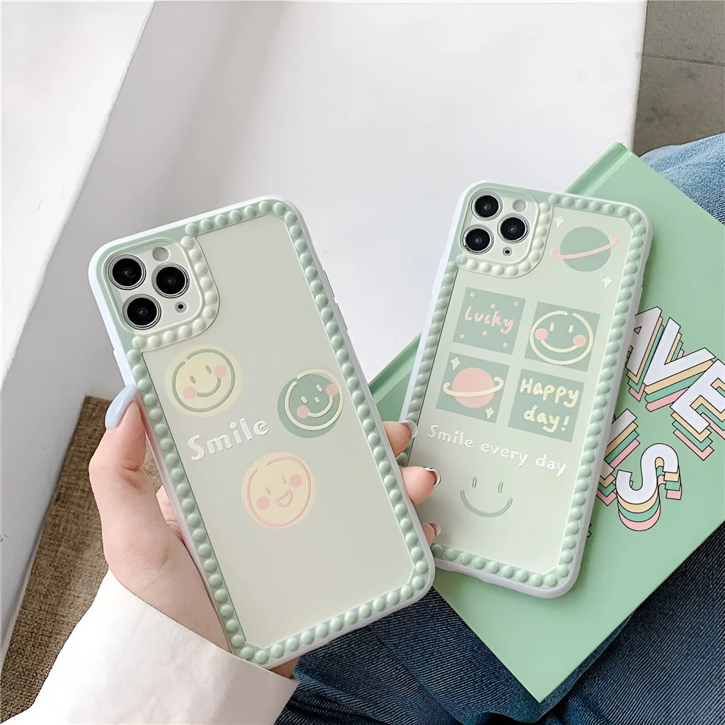 Green iPhone case with geometric pattern and smiley face polka dot design on a soft TPU back cover.
