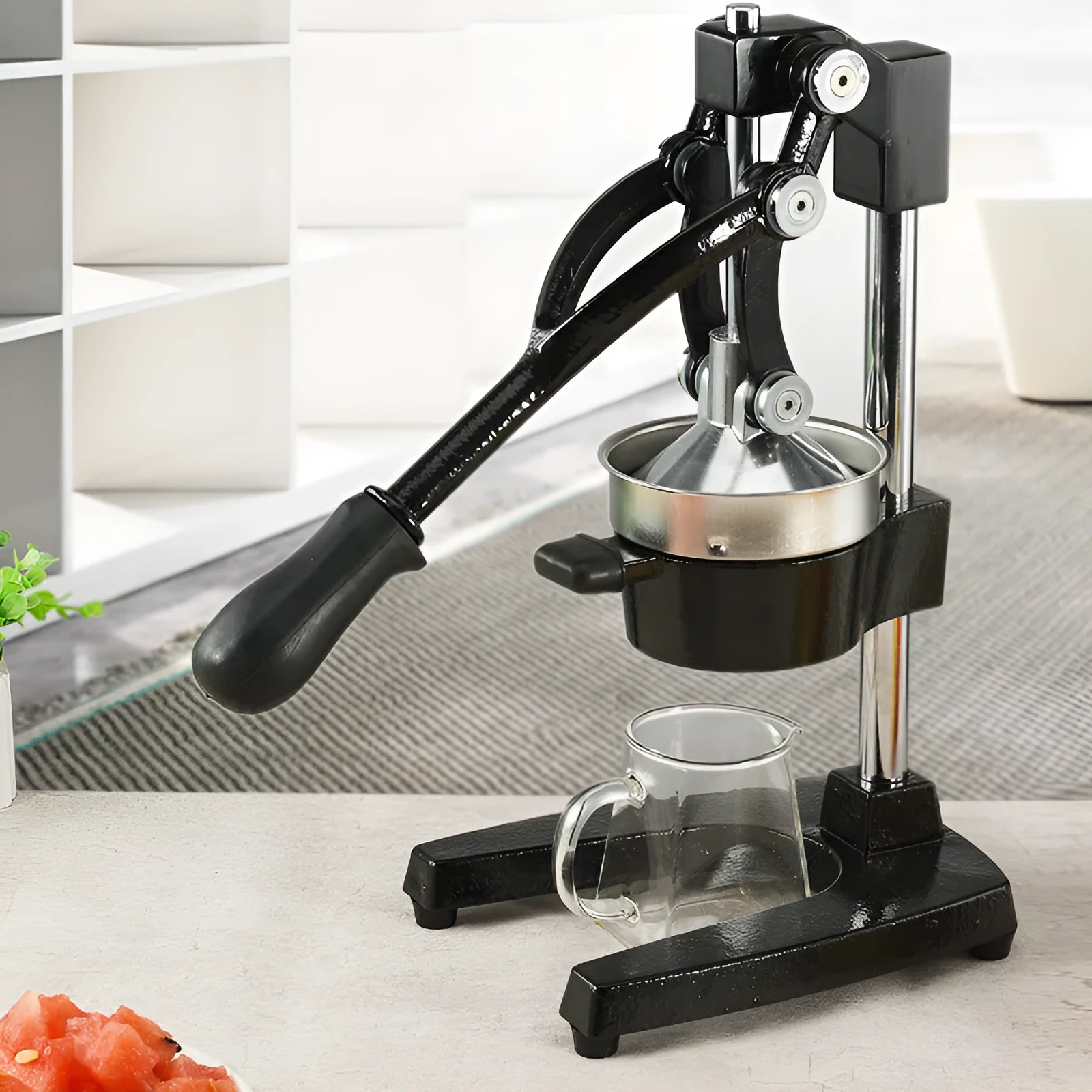 Black and white cast iron manual citrus juicer with stainless steel strainer, 40cm tall