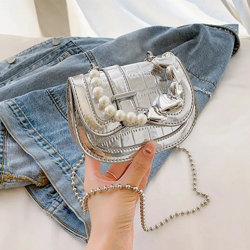 Laser pearl tote saddle girl mini crossbody bag in a horizontal square shape, shown in silver colour.