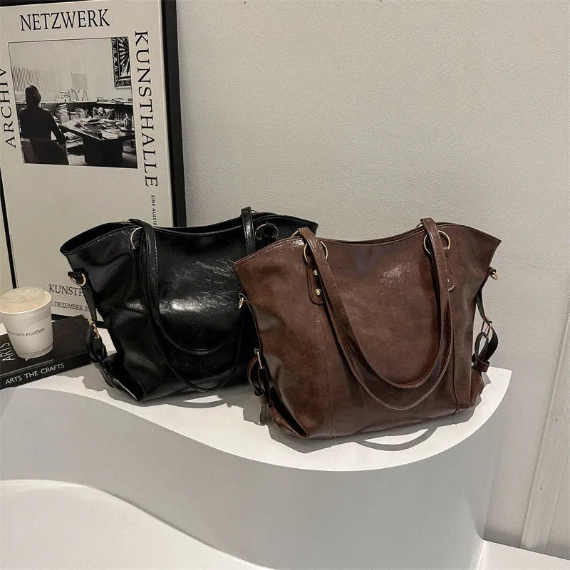 Soft PU retro commuter tote bag with synthetic leather lining, double shoulder straps, and zip hidden pocket in black or brown.