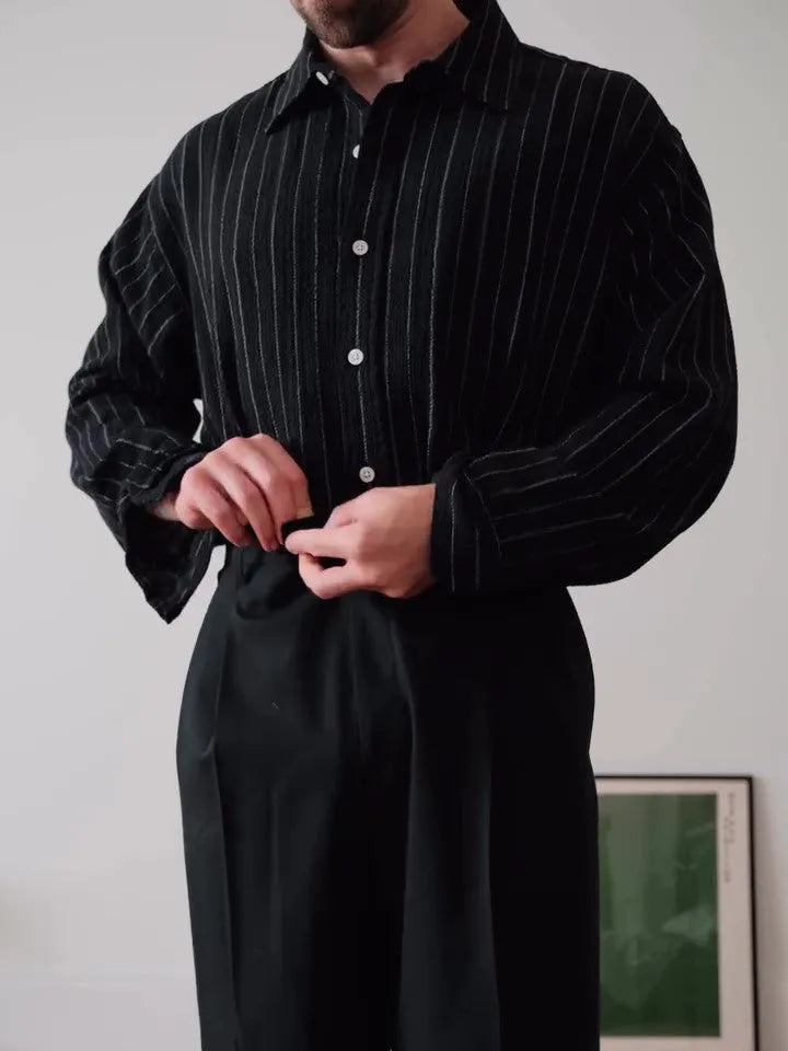 Black pinstriped button-down shirt with regular fit on a model.
