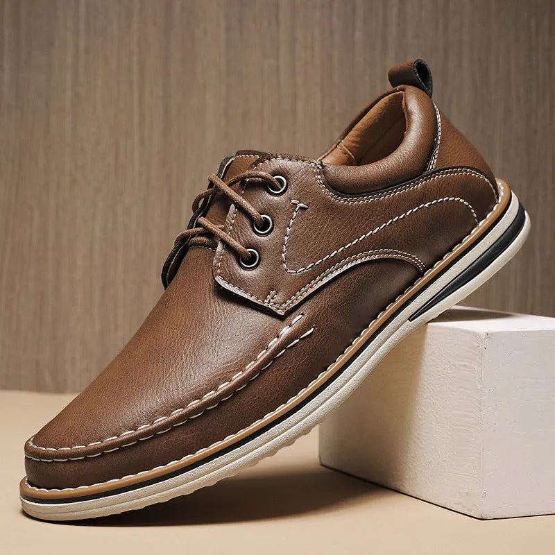 Men's genuine cowhide leather casual shoes in black with round toe and front lace-up design on a neutral background
