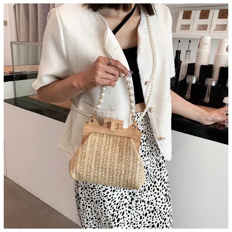 Women's straw shoulder bag with woven pearl chain detail and multiple internal compartments