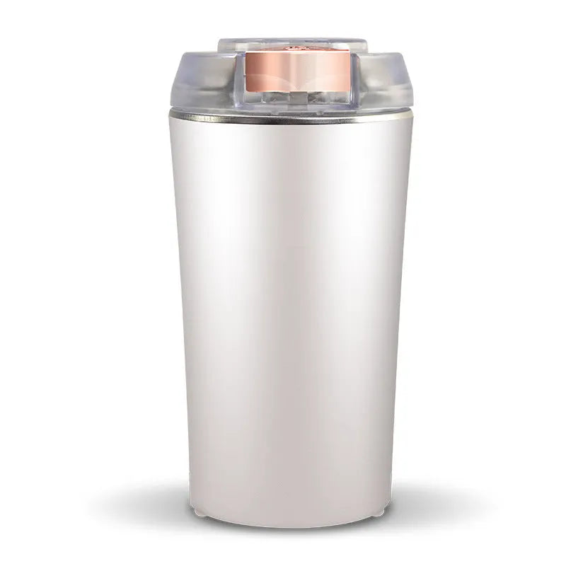 Blue stainless steel mini flour mill and grain grinder machine on a kitchen countertop.