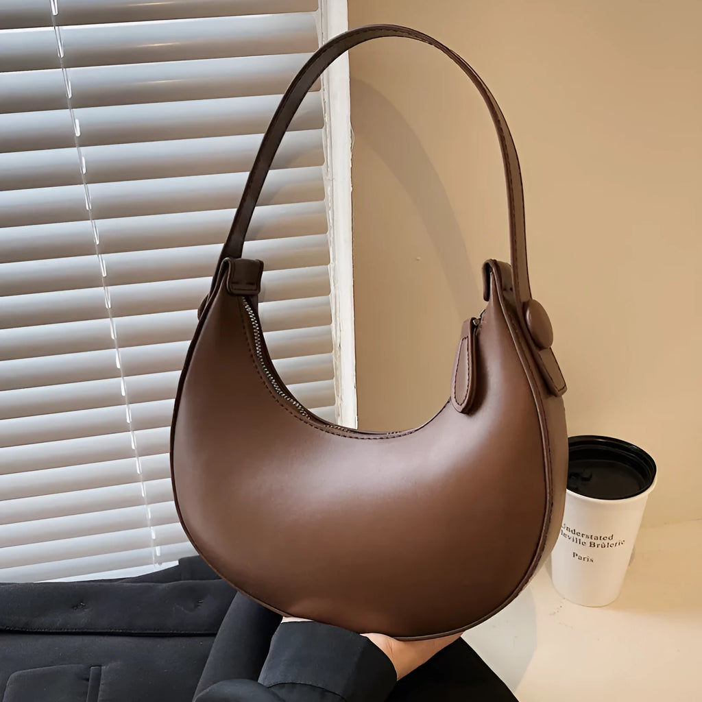 Retro dumpling-shaped women's shoulder bag in PU leather with a zippered pocket.