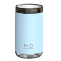 White jellyfish smoke ring humidifier with warm night light on a wooden surface
