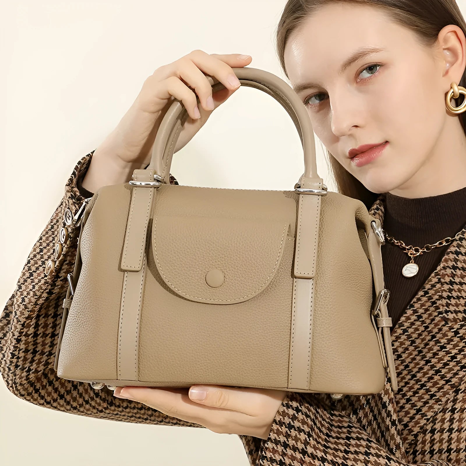 Genuine leather ladies' handbag in black with stitching detail, measuring 27cm wide