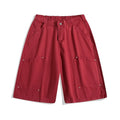 Women's apricot workwear-style cropped pants with wide legs and pocket rivets.