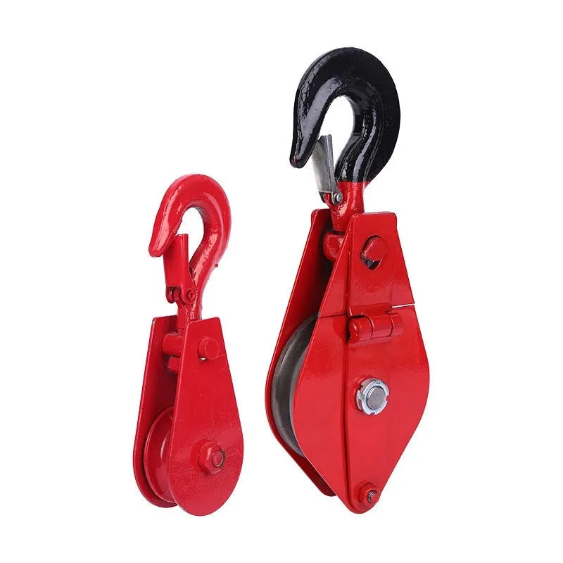 Small red industrial lifting pulley with a steel hook and safety latch for wire rope.