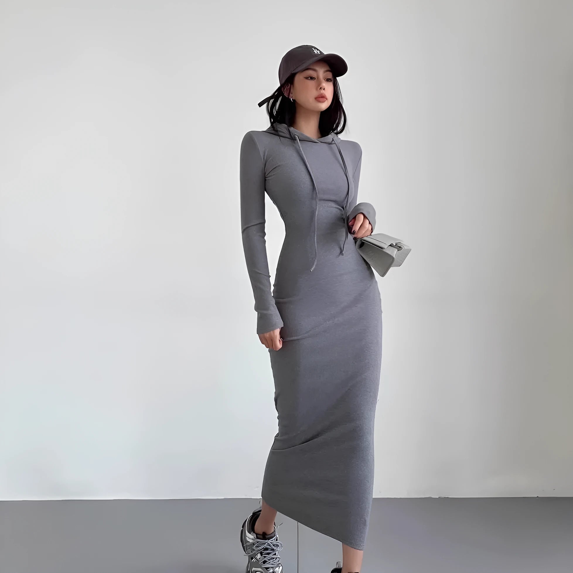 Women's long hooded dress with long sleeves and a sheath silhouette in polyester.